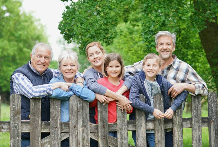 Family Leaning On A Fence